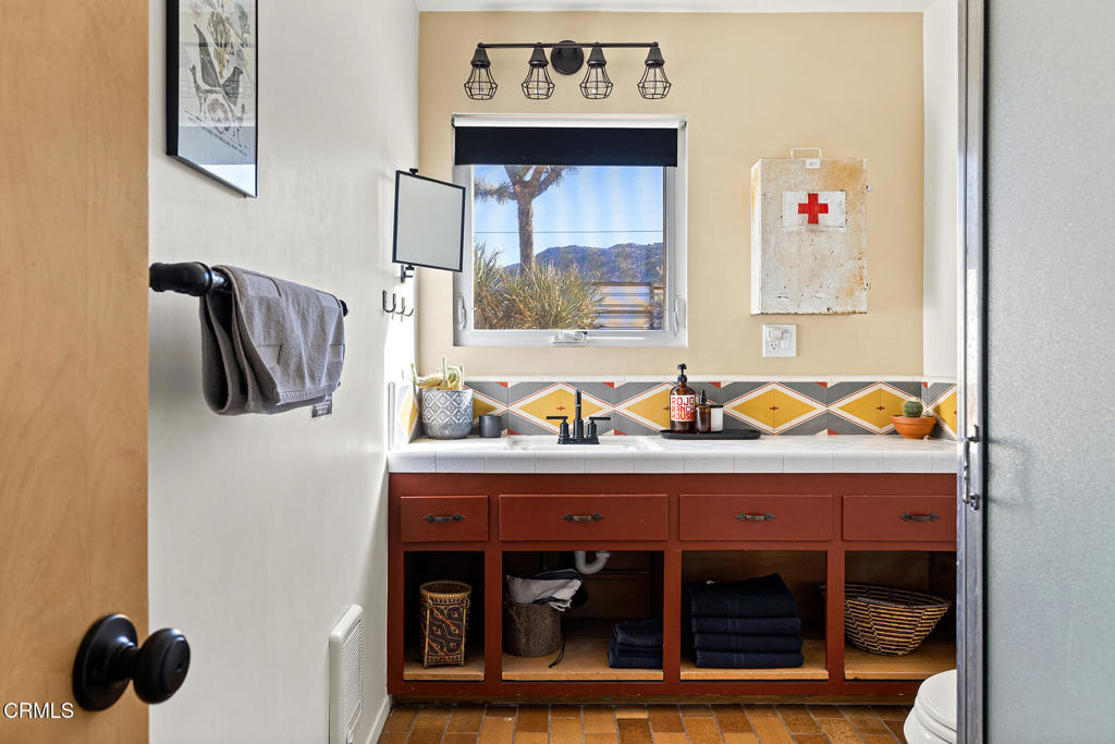 7284 Saddleback Road Joshua Tree, CA 92252 - Photo 23 of 47 a bathroom with a sink and a mirror
