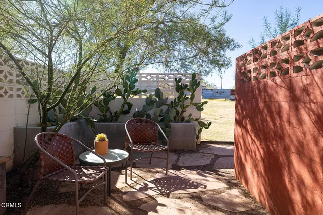a view of a chairs and table in the patio