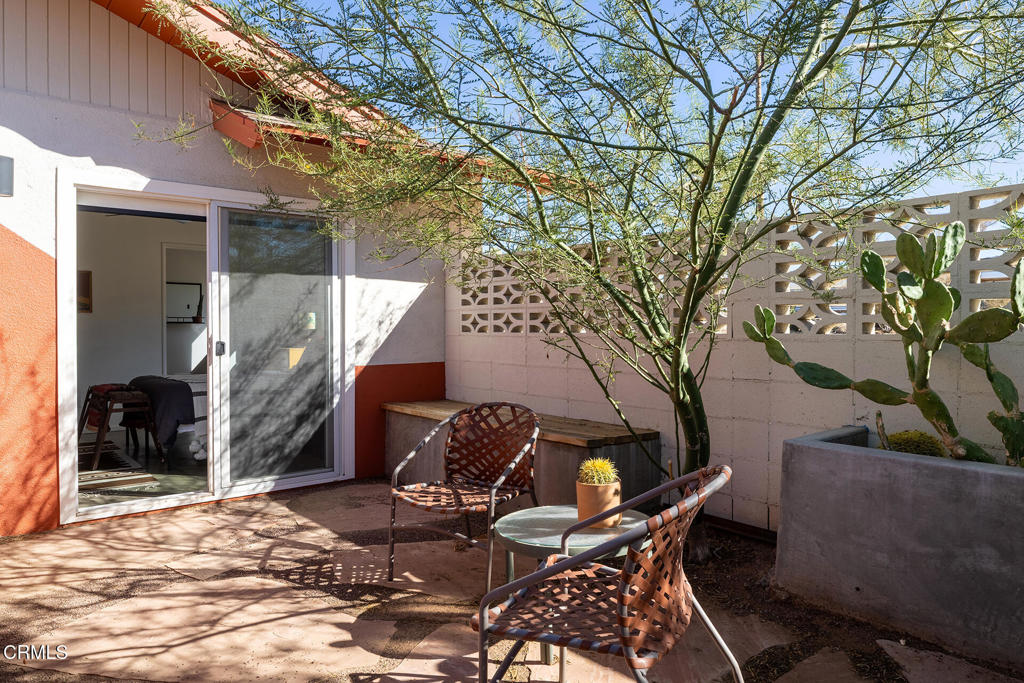 7284 Saddleback Road Joshua Tree, CA 92252 - Photo 26 of 47 a backyard of a house with table and chairs