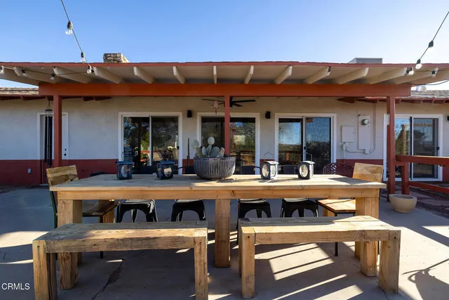 a view of a kitchen with table and chairs