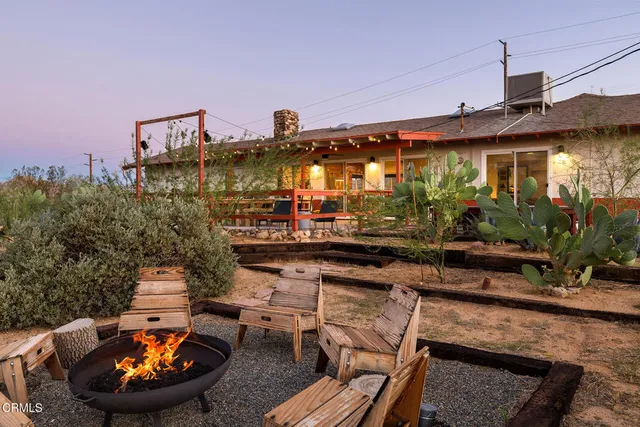 a view of a house with swimming pool and furniture