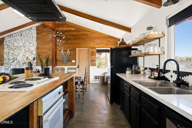a kitchen with stainless steel appliances granite countertop a sink and cabinets