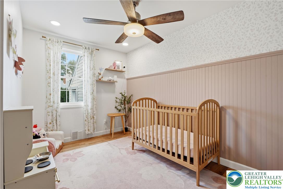 408 Maple Road Hellertown, PA 18055 - Photo 21 of 66 Polished hardwood flooring and elegant wainscoting highlight this charming and peaceful nursery space.
