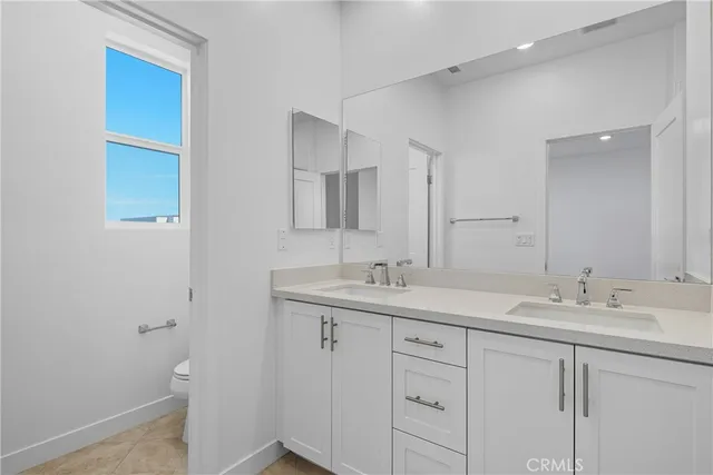 a bathroom with a shower sink and mirror