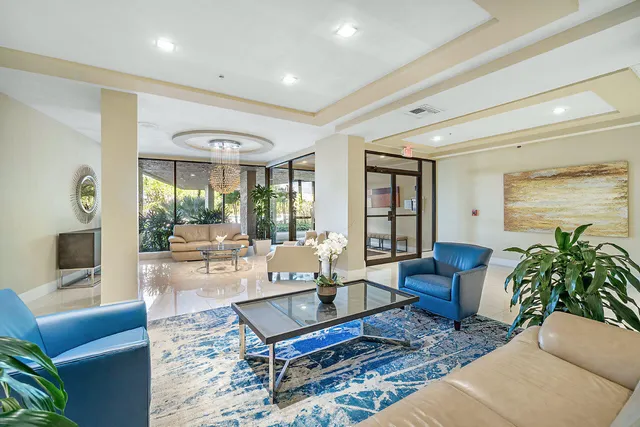 a living room with furniture couches and a dining table with garden view