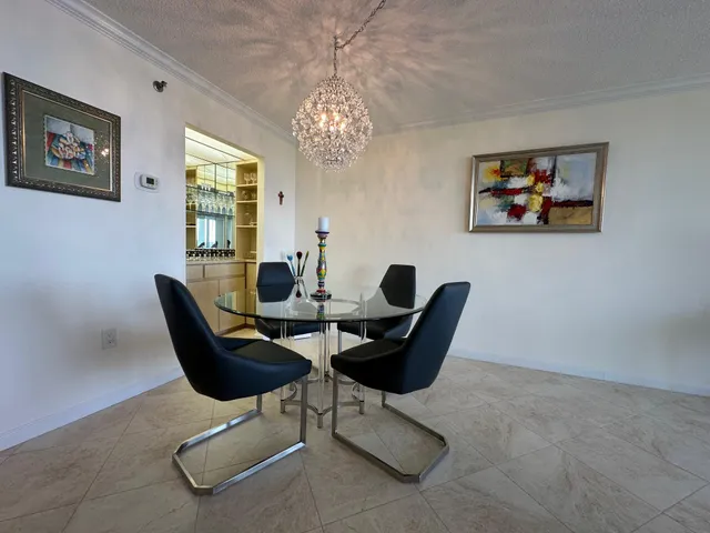 a dining room with furniture and a chandelier