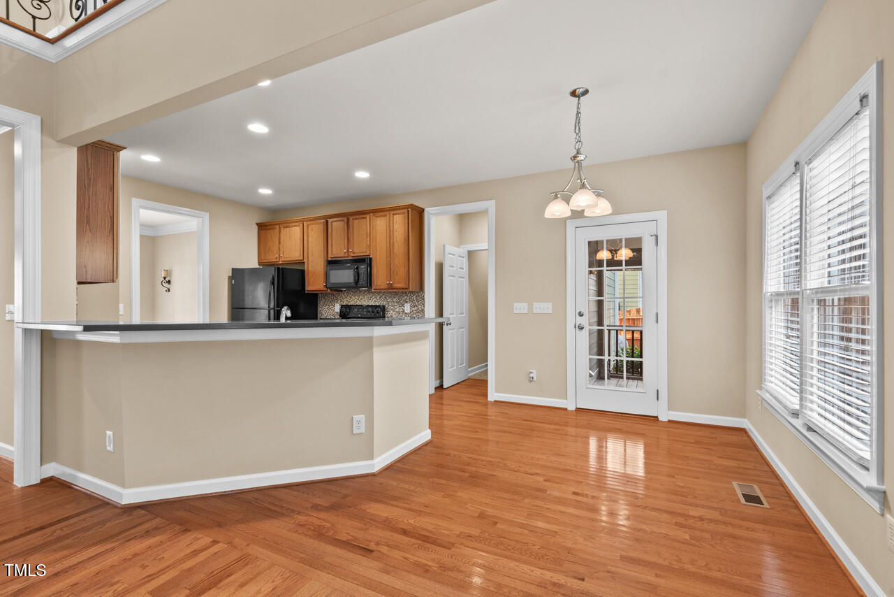 6116 Tiffield Way Wake Forest, NC 27587 - Photo 11 of 39 a view of a kitchen with kitchen island wooden floor center island and stainless steel appliances