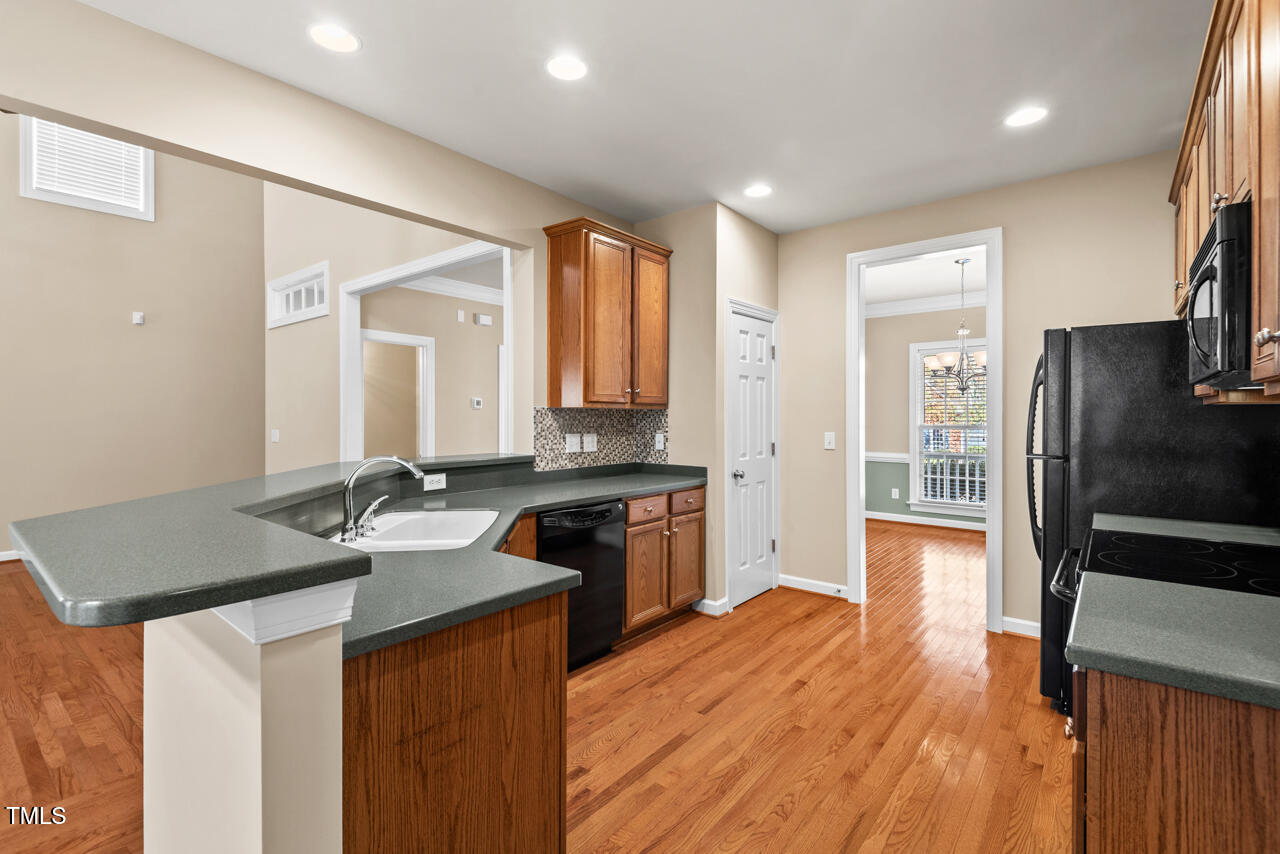 6116 Tiffield Way Wake Forest, NC 27587 - Photo 12 of 39 a kitchen with a sink stove and refrigerator