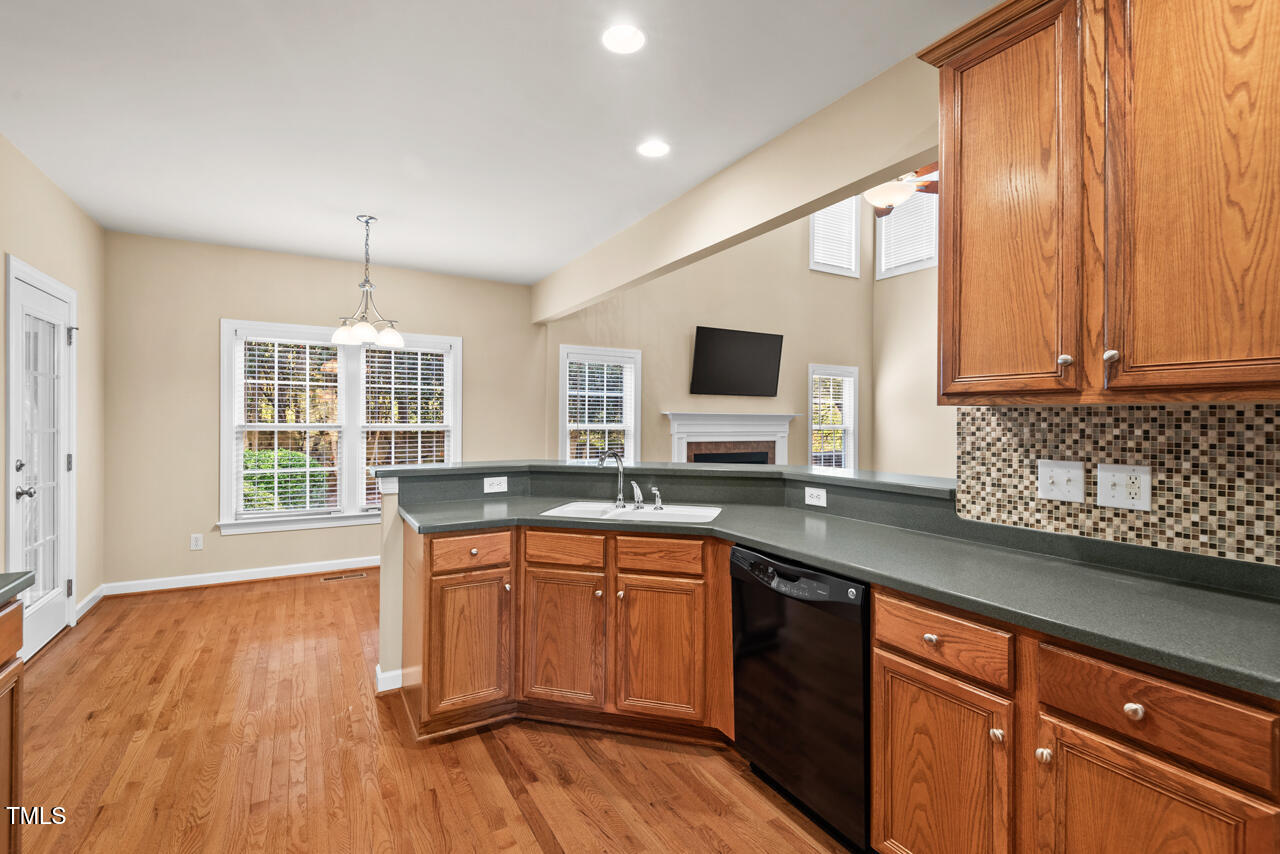 6116 Tiffield Way Wake Forest, NC 27587 - Photo 13 of 39 a kitchen with stainless steel appliances granite countertop white cabinets a sink and dishwasher with wooden floor