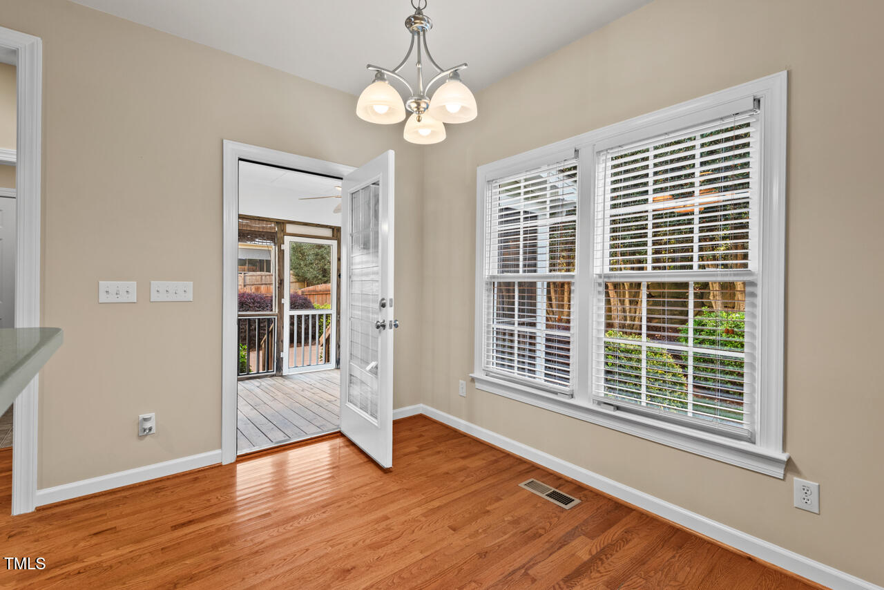 6116 Tiffield Way Wake Forest, NC 27587 - Photo 14 of 39 a view of an empty room with wooden floor and a window