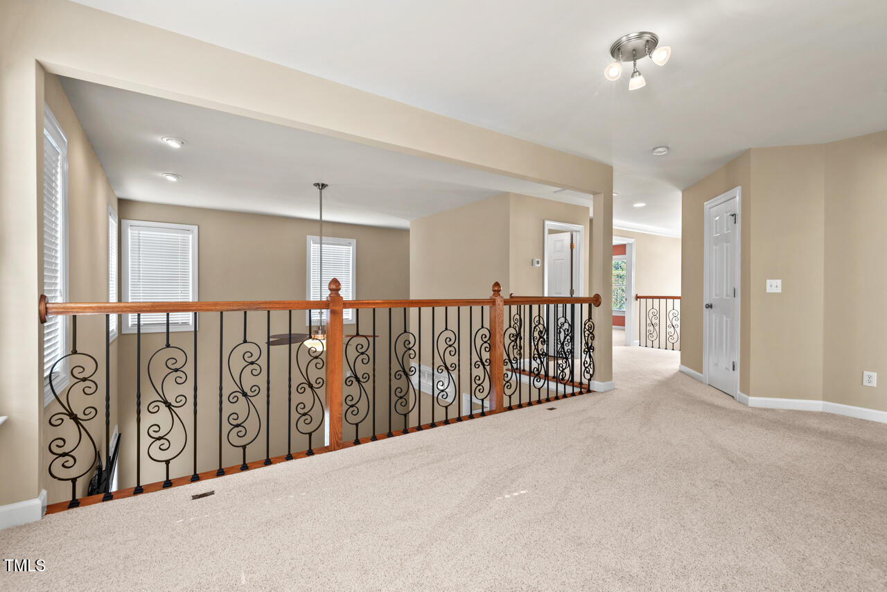 6116 Tiffield Way Wake Forest, NC 27587 - Photo 20 of 39 a view of a hallway with wooden stairs