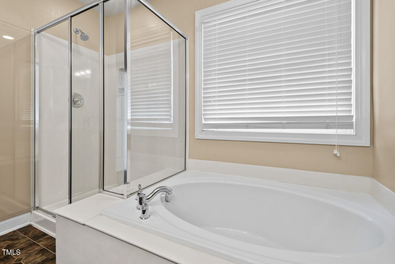 6116 Tiffield Way Wake Forest, NC 27587 - Photo 24 of 39 a bathroom with a bathtub and a sink