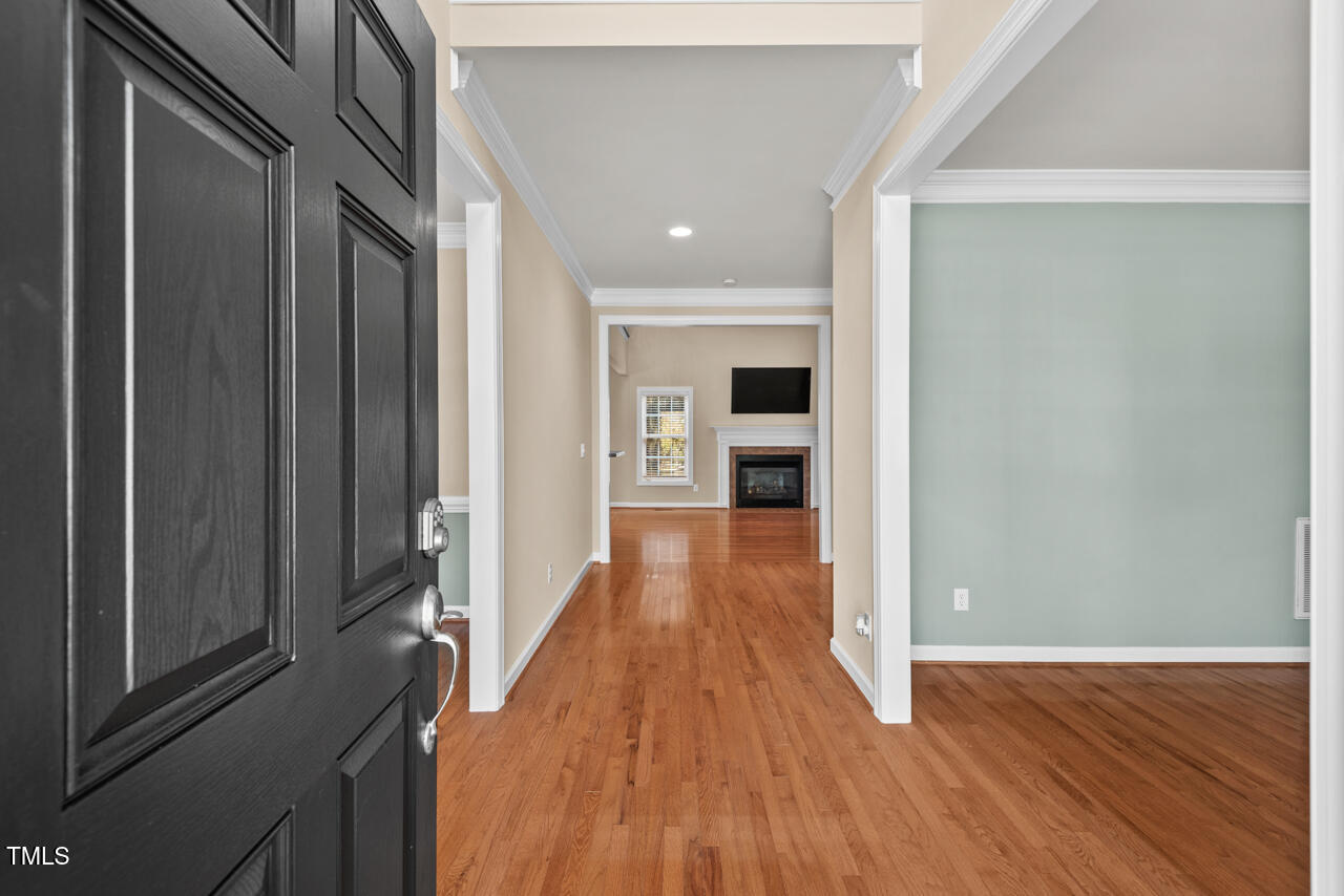 6116 Tiffield Way Wake Forest, NC 27587 - Photo 3 of 39 a view of a hallway with wooden floor and staircase