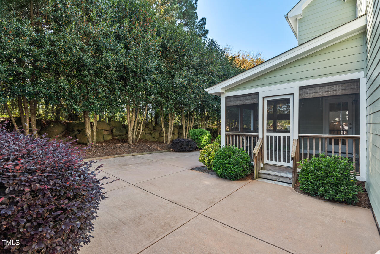 6116 Tiffield Way Wake Forest, NC 27587 - Photo 32 of 39 a view of a house with potted plants and a large tree