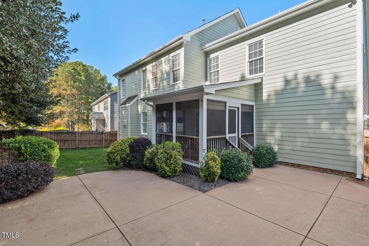 6116 Tiffield Way Wake Forest, NC 27587 - Photo 34 of 39 a view of a brick house with plants and large windows