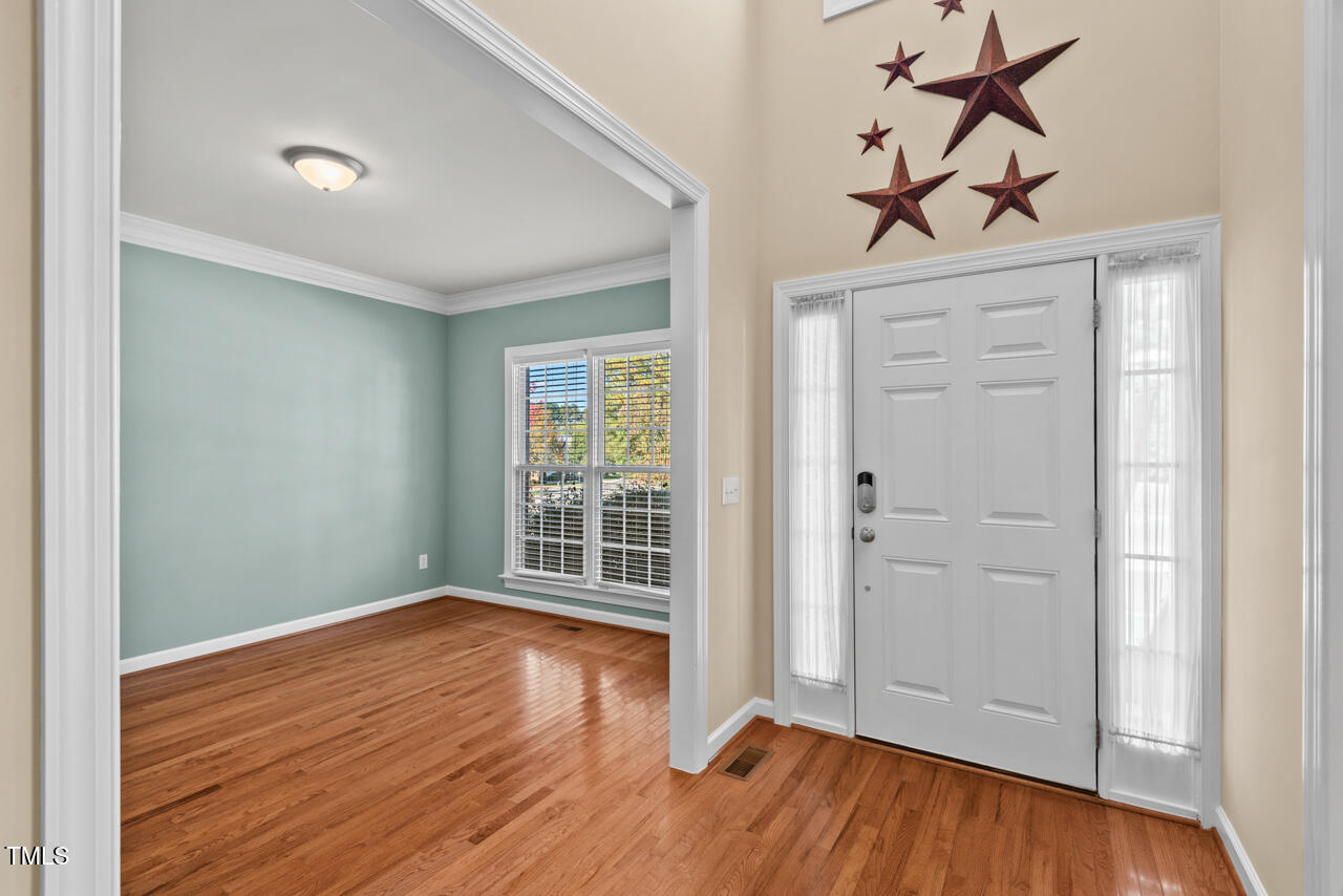 6116 Tiffield Way Wake Forest, NC 27587 - Photo 4 of 39 wooden floor in an empty room with a window