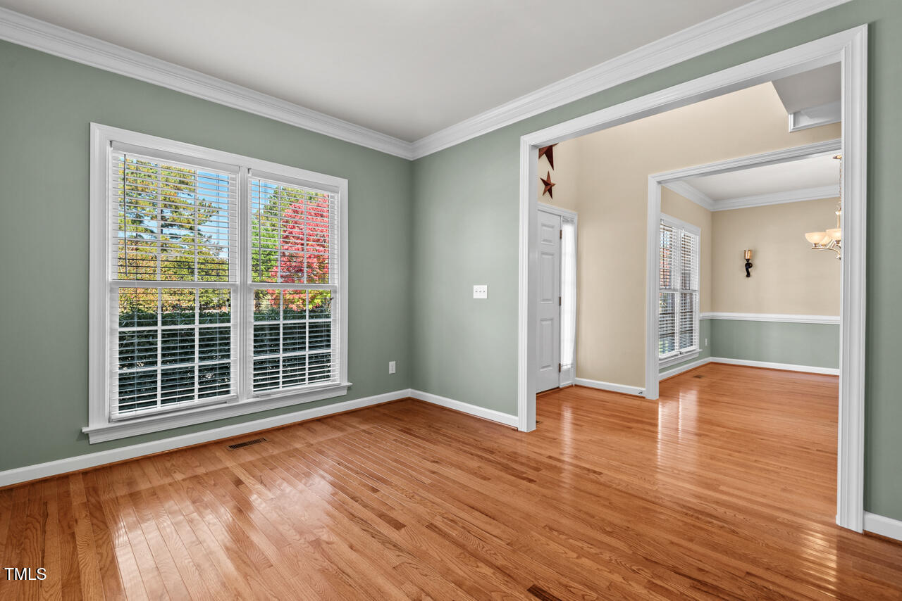 6116 Tiffield Way Wake Forest, NC 27587 - Photo 5 of 39 a view of an empty room with wooden floor and a window