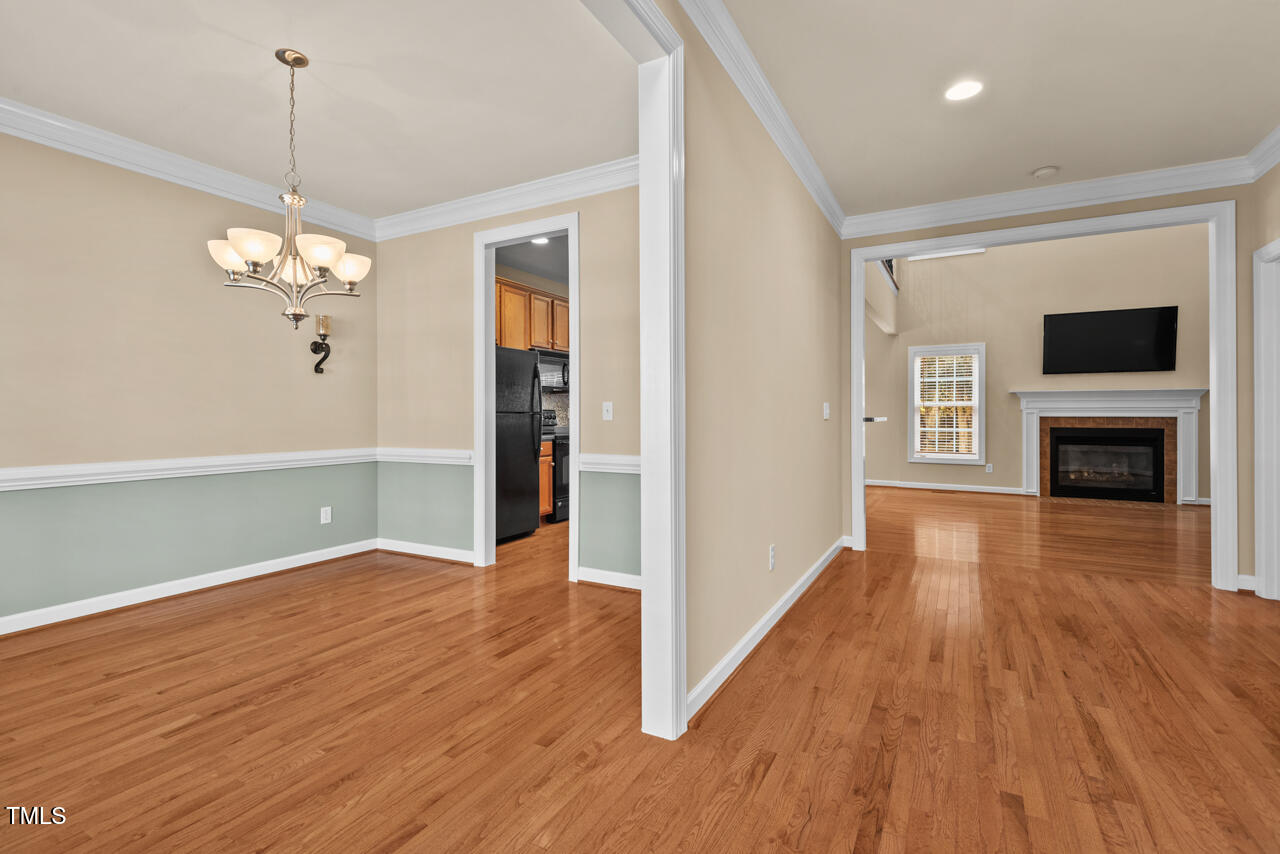 6116 Tiffield Way Wake Forest, NC 27587 - Photo 6 of 39 a view of a livingroom with wooden floor and a ceiling fan