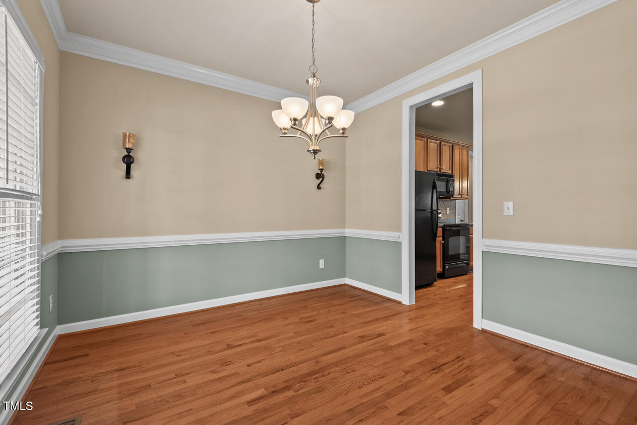 6116 Tiffield Way Wake Forest, NC 27587 - Photo 7 of 39 a view of a room with wooden floor and chandelier