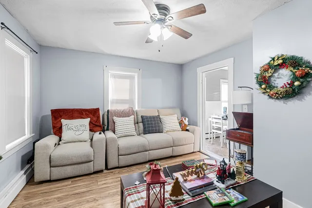 a living room with furniture and a chandelier