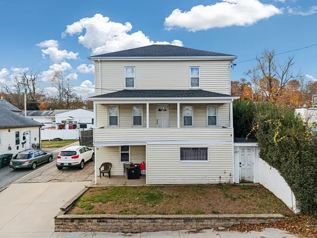 a view of a cars park in front of a house