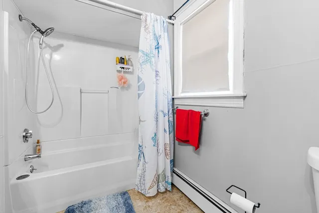 a bathroom with a bathtub and a shower