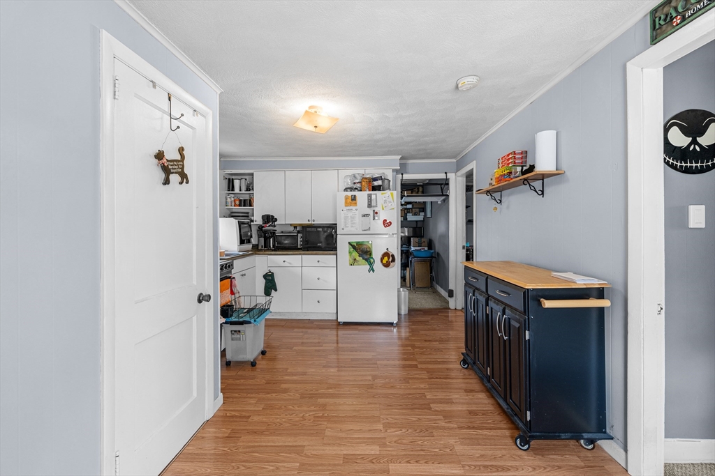 58 Read Avenue Coventry, RI 02816 - Photo 23 of 36 a kitchen with stainless steel appliances a refrigerator and a wooden floor