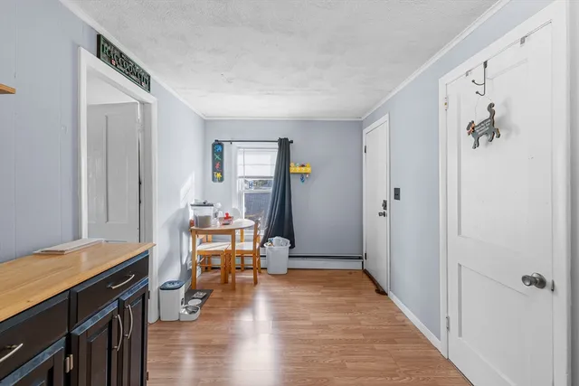 a view of a room with wooden floor and furniture