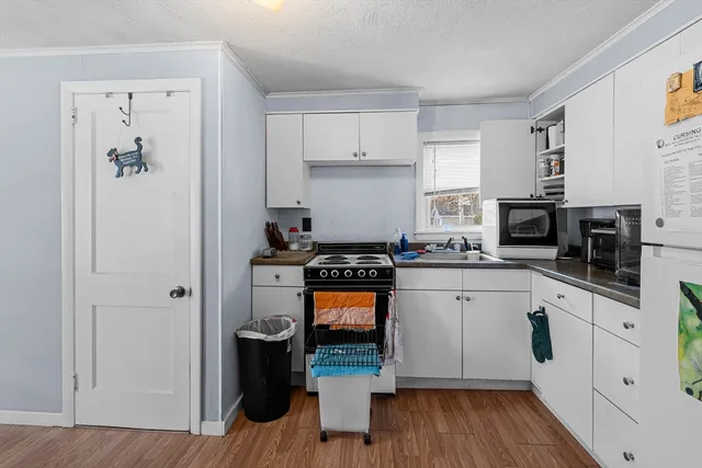 a kitchen with stainless steel appliances a stove top oven a sink and a refrigerator