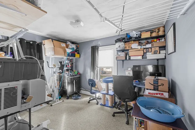 a view of a workspace with furniture and a window