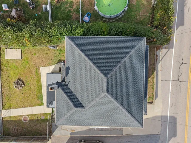 aerial view of a house with a yard