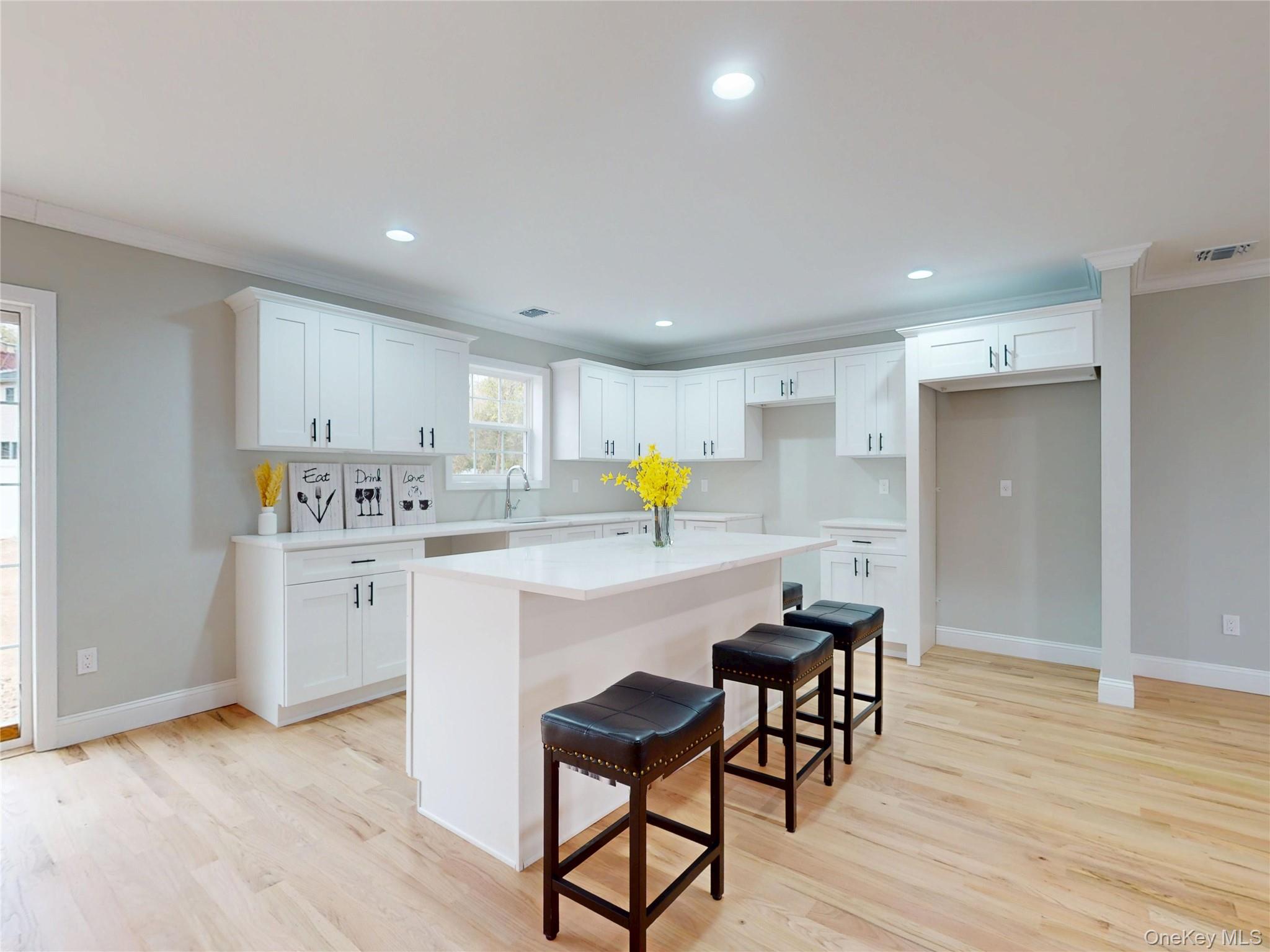 492 Blue Point Road Farmingville, NY 11738 - Photo 7 of 21 a kitchen with a sink cabinets and wooden floor