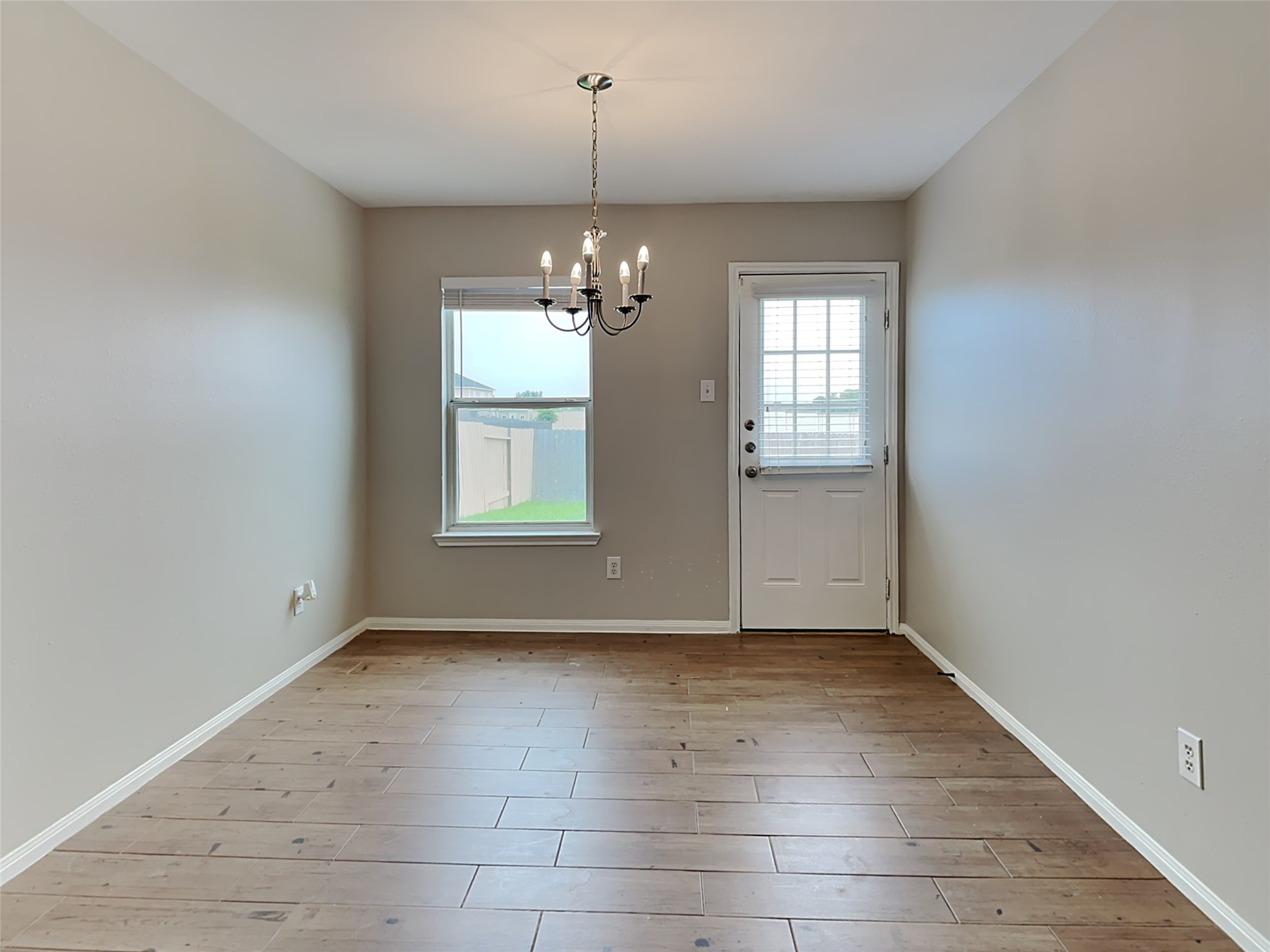 8119 Katie Mill Trail Spring, TX 77379 - Photo 15 of 18 an empty room with chandelier and windows