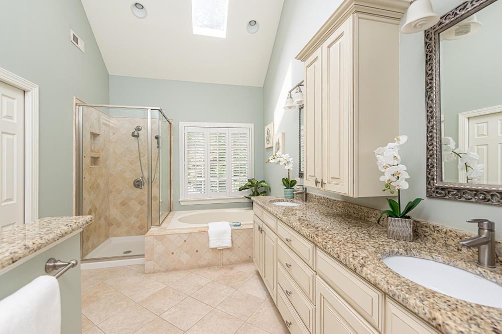 313 Jellison Court Raleigh, NC 27615 - Photo 20 of 30 Primary Bathroom with dual vanity sinks, garden tub, walk in shower, and skylights. Primary Bathroom
