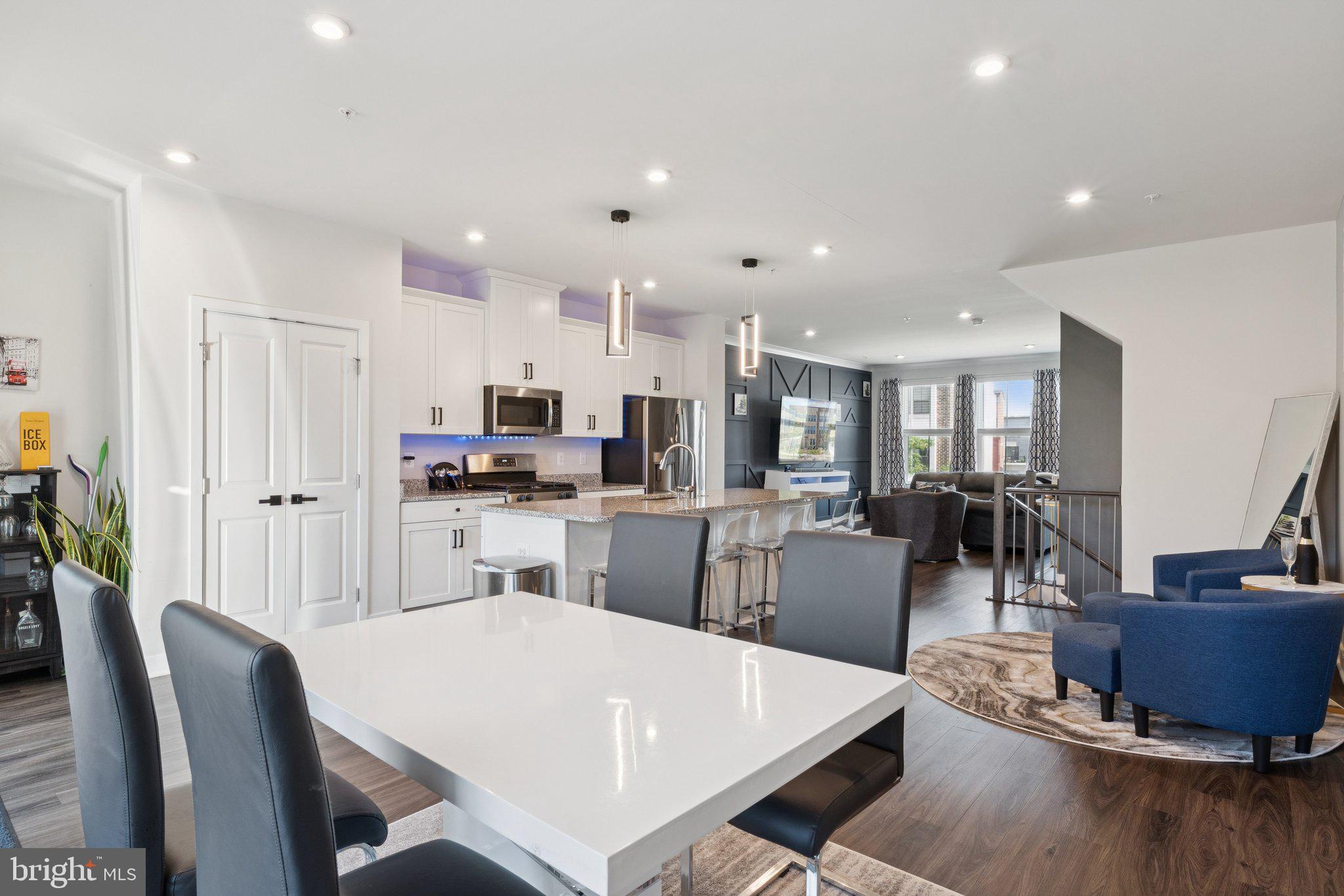 2823 Toles Park Drive Suitland, MD 20746 - Photo 15 of 46 a kitchen with a dining table chairs and wooden floor