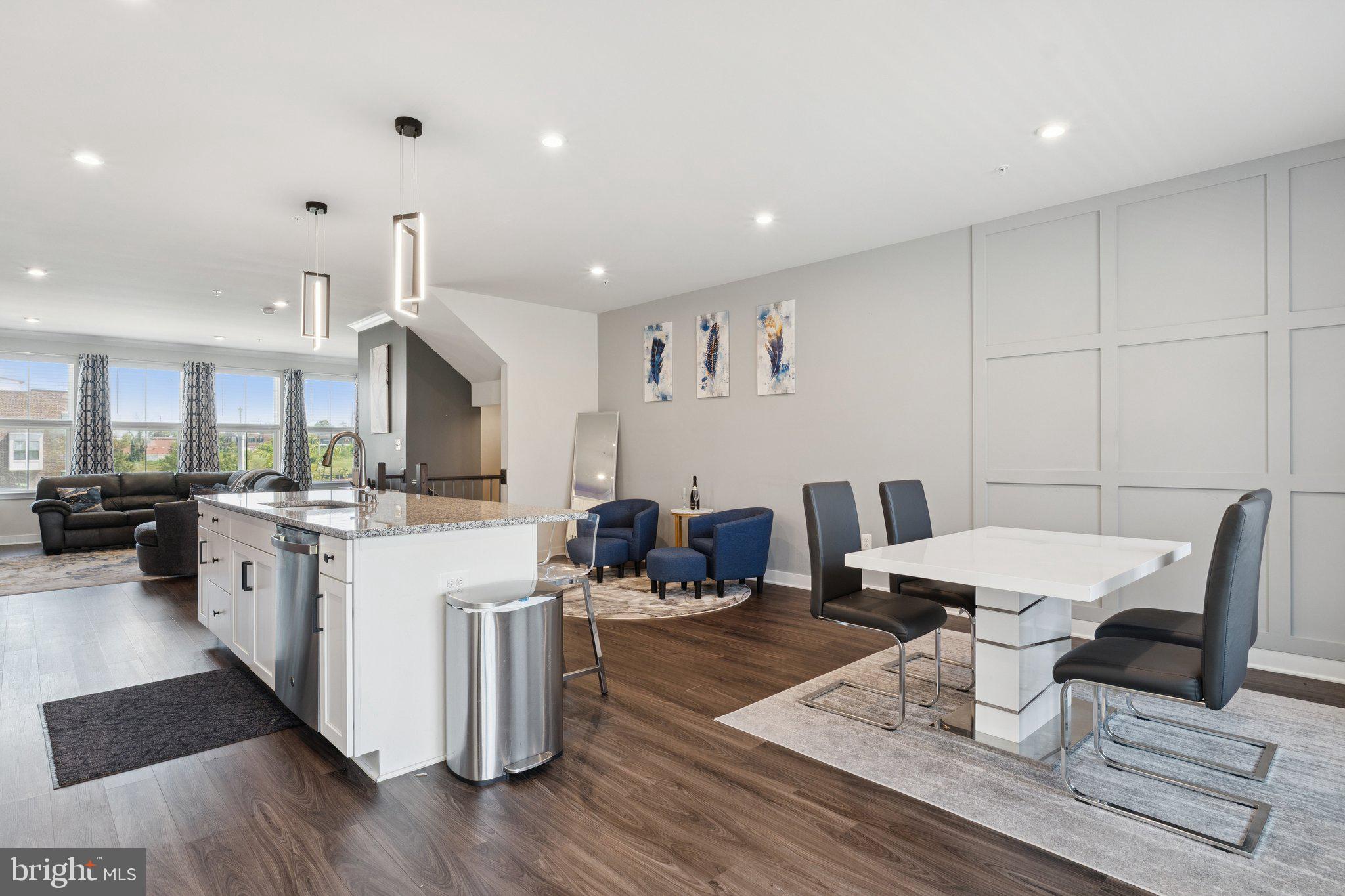 2823 Toles Park Drive Suitland, MD 20746 - Photo 16 of 46 a kitchen with a dining table chairs and white cabinets