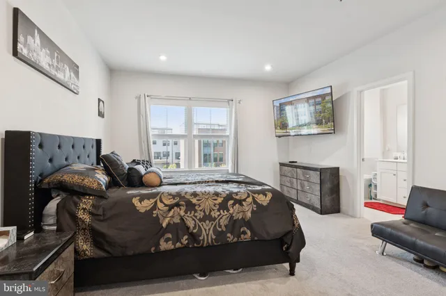 a bedroom with a bed couch and a couch