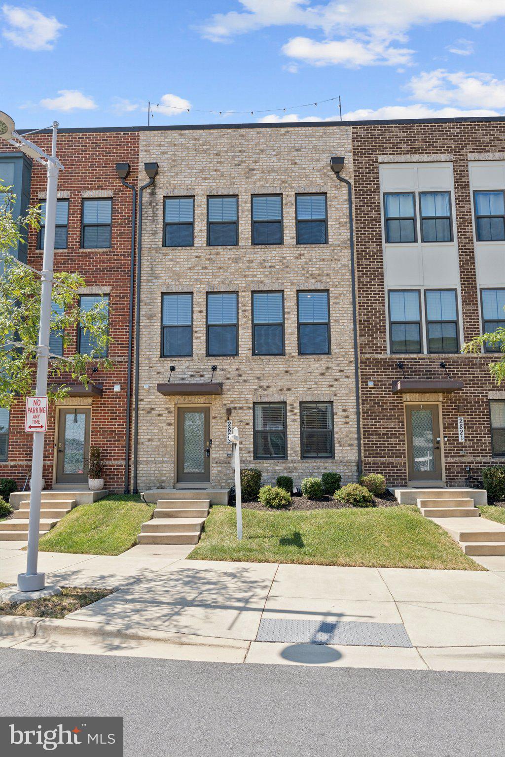 2823 Toles Park Drive Suitland, MD 20746 - Photo 3 of 46 a front view of a building with a garden and plants