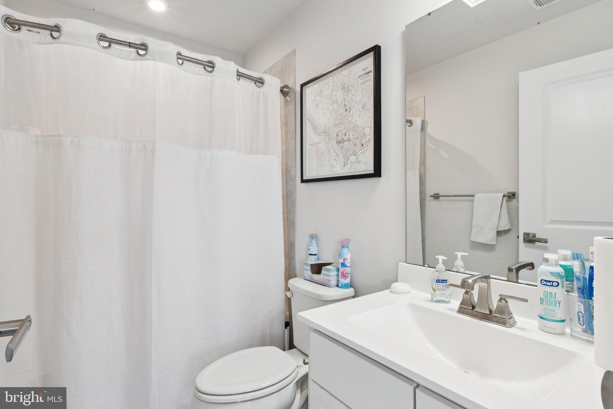 2823 Toles Park Drive Suitland, MD 20746 - Photo 32 of 46 a bathroom with a sink vanity mirror and toilet
