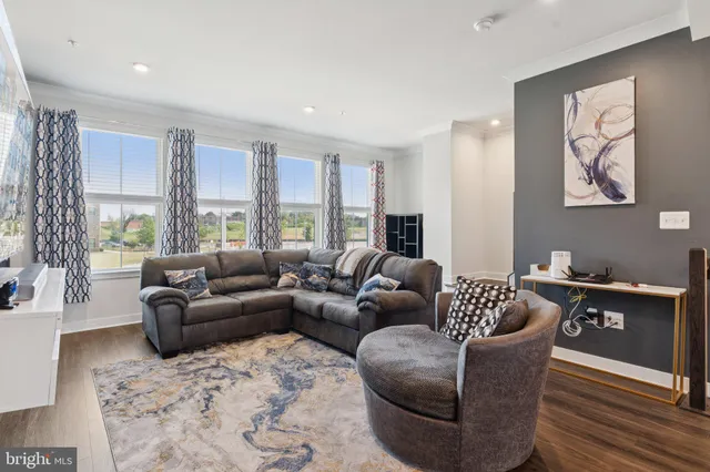 a living room with furniture and kitchen view