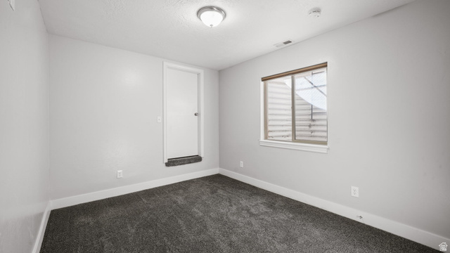 45 North 970 W Street Orem, UT 84057 - Photo 30 of 45 Spare room with dark carpet and a textured ceiling