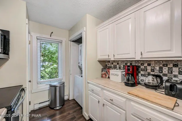a view of a livingroom with furniture wooden floor a fireplace
