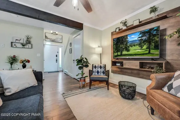 a view of a livingroom with furniture window and wooden floor
