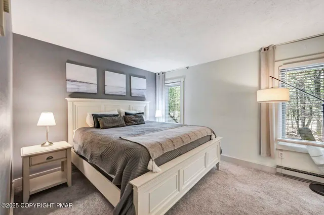 a view of a house with backyard and a tree