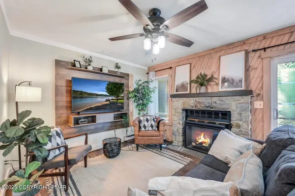 a living room with furniture fireplace and flat screen tv