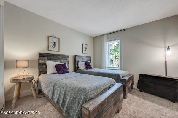 a view of a brick house next to a yard with large trees