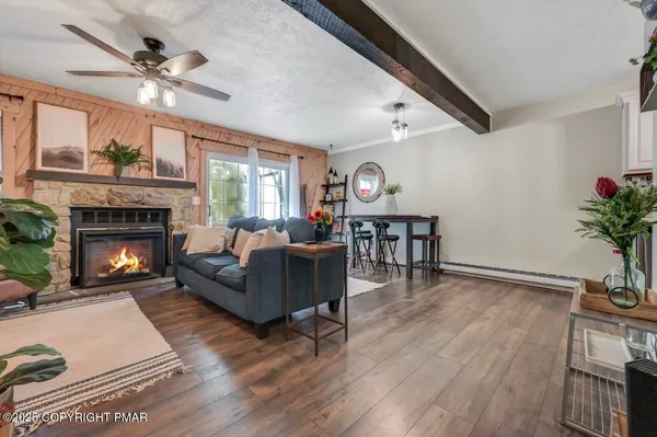 a living room with furniture and flat screen tv