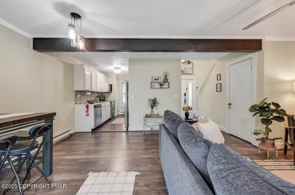 a view of living room with furniture and a fireplace
