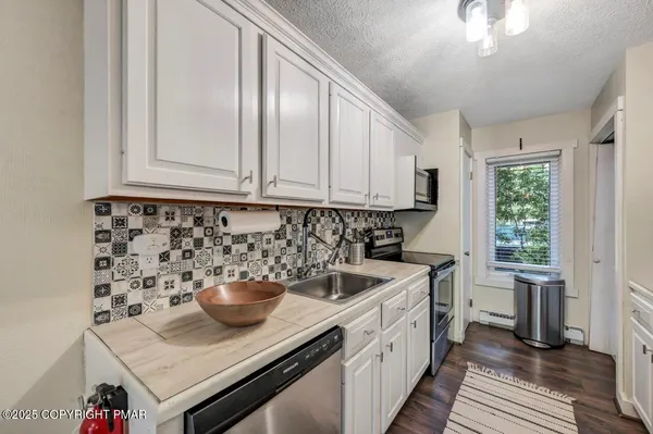a kitchen with a sink and a refrigerator