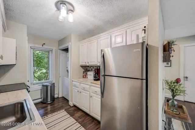 a view of washer and dryer with kitchen view